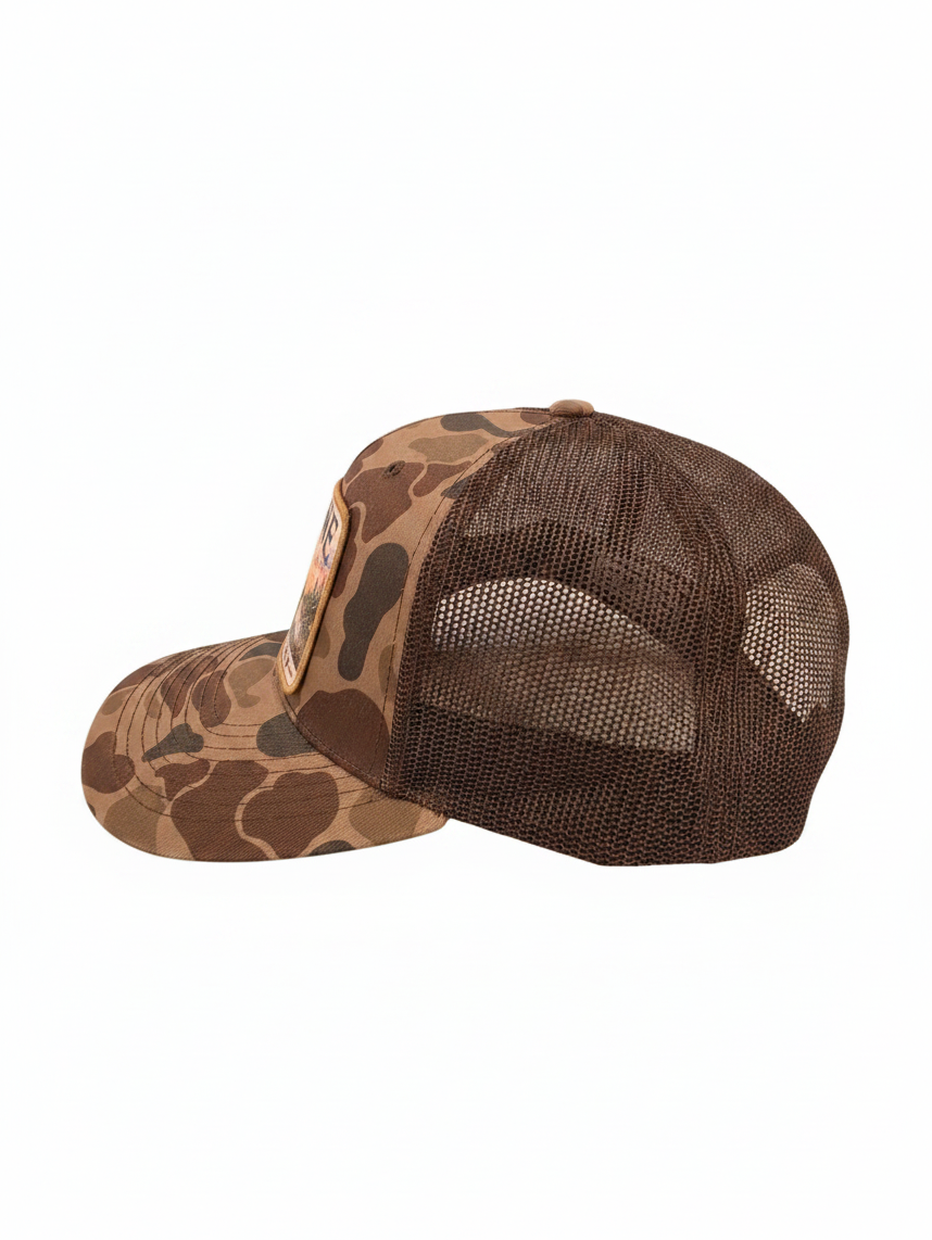 Sabine Outfitters camo trucker hat with a brown mesh back and a turkey patch, side view on a white background.