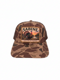 Sabine Outfitters camo trucker hat with a turkey patch, brown mesh back, and adjustable snapback closure.